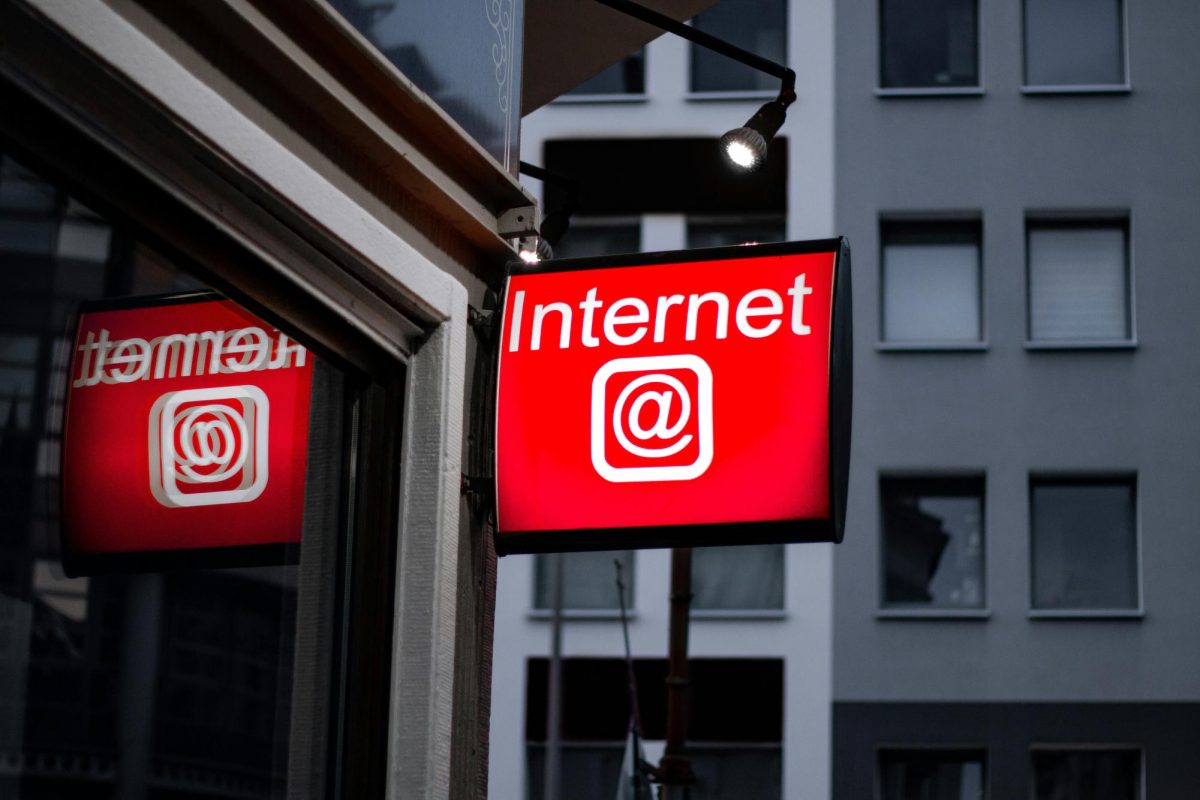 Photo of a red Internet Cafe Logo in a city 
