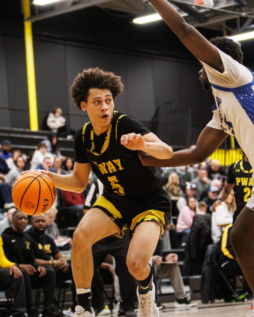 Piscataway Junior Guard, Izayah Brown (#5) dribbling past Sayreville Senior Forward, Chidi Chukwuarah (#45)